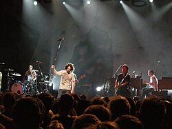 Counting Crows in Brussels, 2008. Left to right: Bogios, Duritz, Immerglück, and Gillingham. Vickrey is cut off at the left, Powers is behind Duritz; Bryson is out of frame.