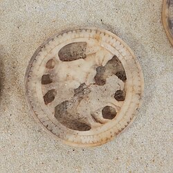 Seated figure with bear