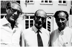 Poul Baastrup, John Cade, and Mogens Schou standing together outside.