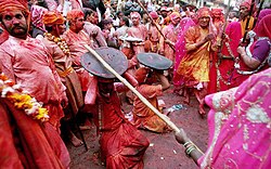 In the Braj region of North India, women have the option to playfully hit men who save themselves with shields; for the day, men are culturally expected to accept whatever women dish out to them. This ritual is called Lath Mar Holi.[103]