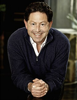 An approximately 48-year-old man looking and smiling at the camera.