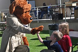 McGruff, left, high-fives two children at right
