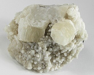 Two sharp pseudohexagonal crystals of witherite on calcite from Hardin County, Illinois (size: 6.4 × 5.4 × 3.4 cm)