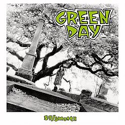 A black-and-white image of a woman standing in a graveyard with a tree behind her