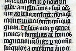 Calligraphy in a Latin Bible of 1407 on display in Malmesbury Abbey, England. This Bible was handwritten in Belgium, by Gerard Brils, for reading aloud in a monastery.