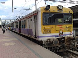 White-and-yellow electric train at a station