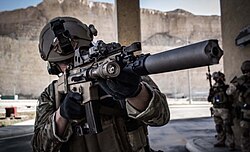 Belgian SFG soldier armed with the SCAR-L with a suppressor