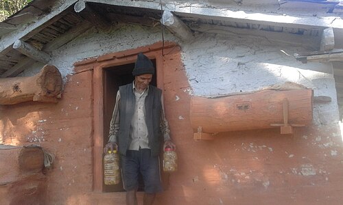 Wooden hives and farmer with packed honey