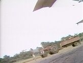 An empty truck sits on an airfield.