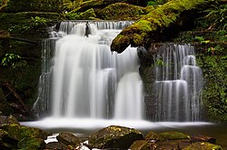 Strickland Falls in Tasmania, Australia, photographed with a neutral density filter. ND filters reduce light evenly across the spectrum, allowing a larger aperture and slower shutter speed without overexposure, creating the motion blur effect.