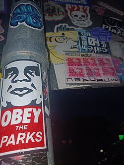 An OBEY Giant sticker created by Shepard Fairey in 1996,[10][35] based on the original Andre the giant has a posse sticker first created by Fairey in 1989.[8] This image has become famous across the world for its ability to parody "Orwellian"[11] propaganda.[13] Darlinghurst, Sydney, 2025.