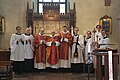 Evangelical-Lutheran acolytes stand alongside priests following High Mass at Holy Trinity Church in Uppsala on the Feast Day of the Apostles Philip and James the Less