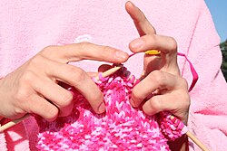 Knitting uses two or more straight needles that carry multiple stitches.