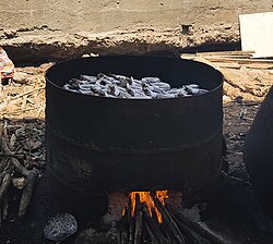 a round metal open fire with small fish