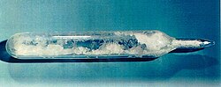 test-tube like glass container, with pointy sealed end, filled with white crystals