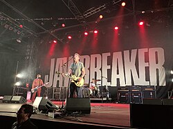 People on a stage performing with instruments