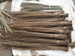 A hard-broom (walís-tingtíng) stall in the Philippines. Philippine hard brooms are often made from the hard primary veins of the leaves of the coconut palm frond.