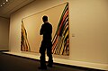 A museum visitor viewing Morris Louis's Beta Zeta at the Neue Nationalgalerie, Berlin[9]