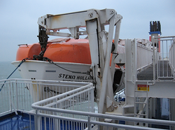 Gravity multi-pivot davit holding rescue vessel on a North Sea ferry
