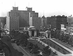 Black and white image of the hotel entrance with a city park in the foreground