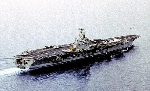 USS Theodore Roosevelt launches an F-14 Tomcat while F/A-18 Hornets wait their turn during the Kosovo War