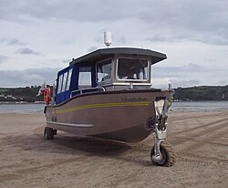 Three-wheeled amphibious boat on the sand