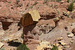 An ancient rockfall which protected the rock records beneath its impact site from further large scale erosion. Taken along Burr Trail, Grand Staircase–Escalante National Monument, Utah, US.