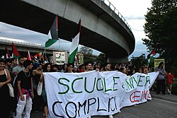 Italian protesters holding the banner and waving Palestine Flag