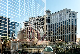 Reflection of Flamingo Las Vegas on a glass overpass in front of the Bellagio and Cosmopolitan
