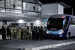 Venezuelan men boarding boarding buses