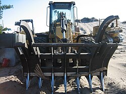 The front of a Caterpillar 930G fitted with loader rake