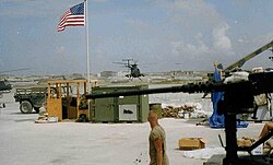 Military airfield, large gun in foreground