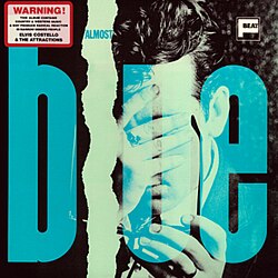 The word "blue" in giant blue letters on top of a man covering his face with his hand.