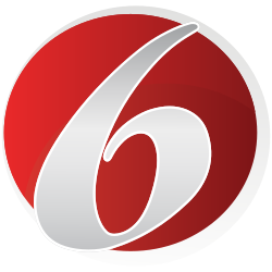 A red circle trimmed in white containing an angled serif numeral 6.