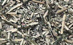 Shredded US dollar with a typical size of 1.5 × 14 mm²