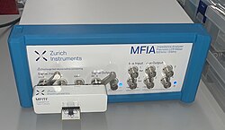Computer controlled impedance analyzer based on the direct I-V mode with test fixture attached.