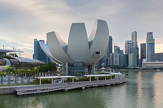 A lotus-inspired building designed by Moshie Safdie that features 10 "fingers" anchored by a unique round base in the middle.