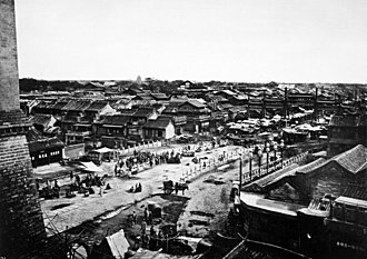 A view from the city wall over the rooftops and courtyard compounds of Beijing, photographed by John Thomson c. 1871