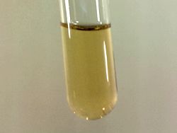 Small sample of pale yellow liquid fluorine condensed in liquid nitrogen