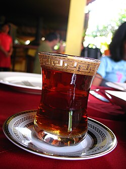 A glass of red-colored tea