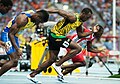 100 m race record holder Usain Bolt (in yellow) and other runners in sportswear