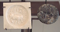 Indus round seal with impression. Elongated buffalo with Harappan script imported to Susa in 2340–2200 BC. Found in the tell of the Susa acropolis. Louvre Museum, reference Sb 5614[62]