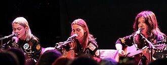 Boygenius performing in 2023. Left to right: Phoebe Bridgers, Julien Baker, and Lucy Dacus