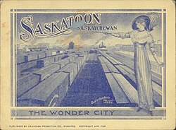 a woman standing over a busy train yard in Saskatoon with the words "Saskatoon, the Wonder City"