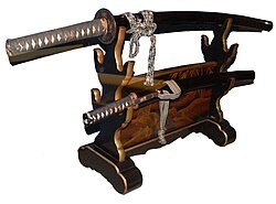 An Edo-period daishō koshirae on its stand. The long-sword is generally stored above the wakizashi, curving downwards. When hung for display, the tip points to the right.