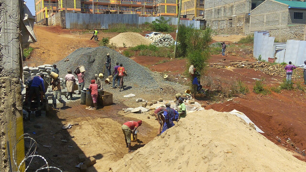 Construction site workers loading water, sand, ballast and cememt into a concrete mixer in Embu, Kenya 1.jpg
