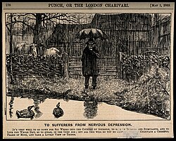 A depressive man standing by a country pond in the pouring rain