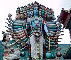 Photo of a statue with many heads and many arms