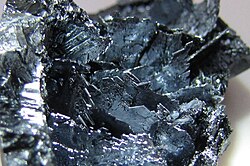 Shiny violet-black colored crystalline shards.