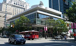 A glass-faced office building on a street corner